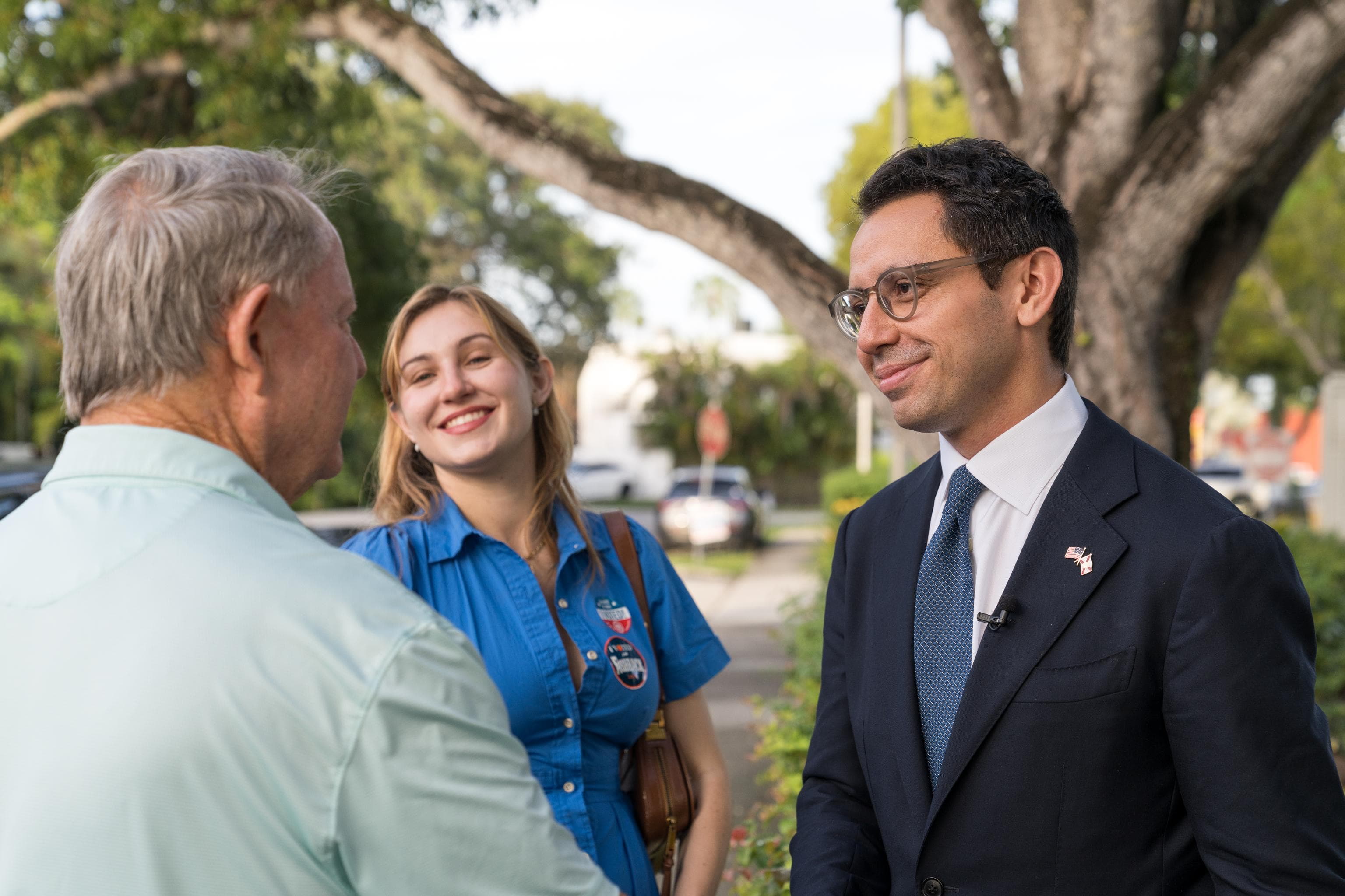 James Fishback talking with a voter on a Florida sidewalk
